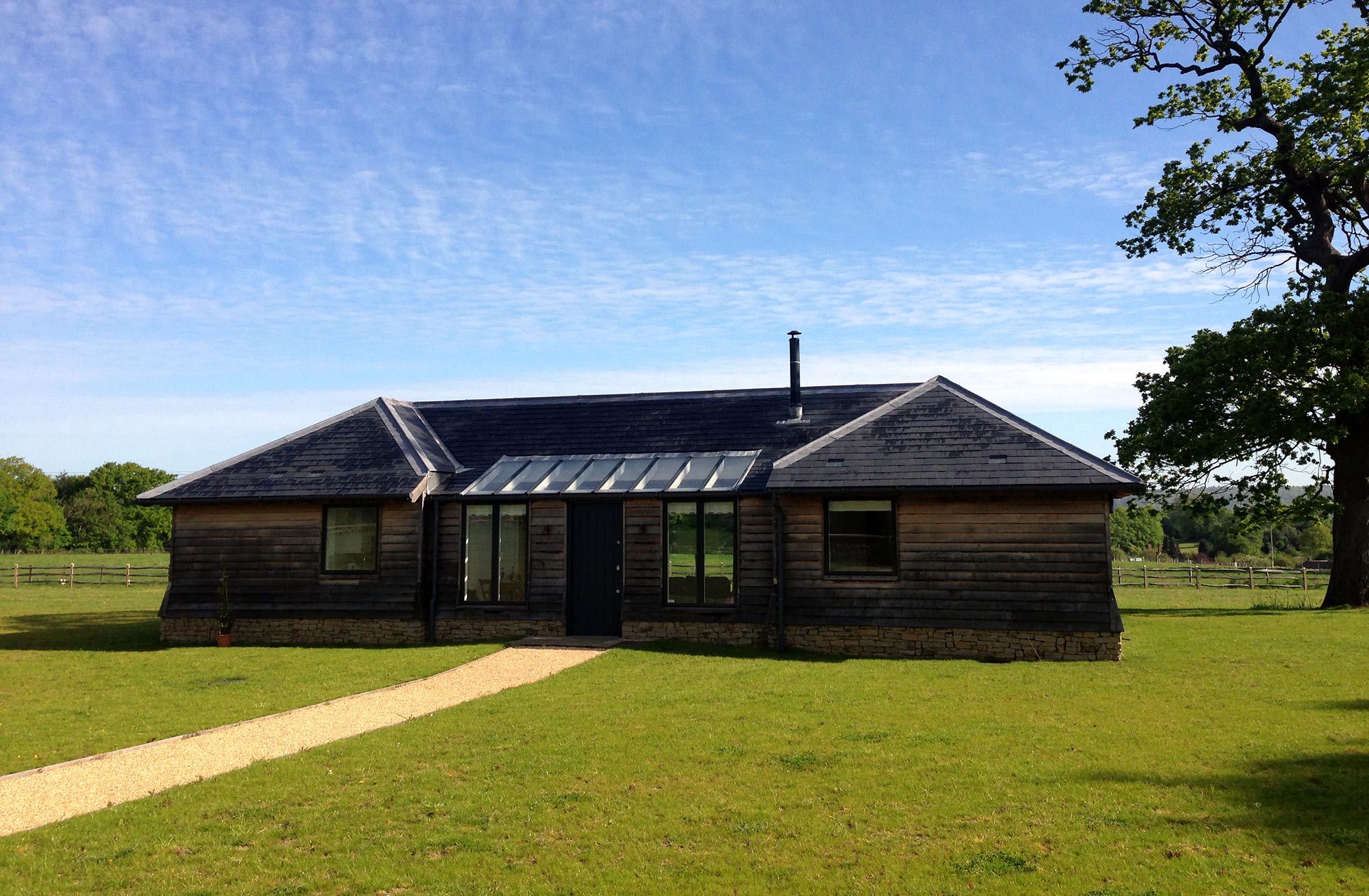 Annex to New build home with oak frame, stone and specialist glass - Castle Eaton Construction, Surrey